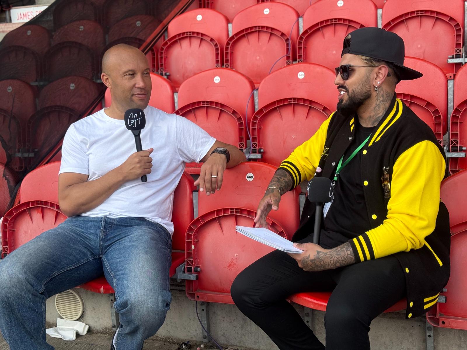 Gerryn Hussain interviewing a guest pitchside