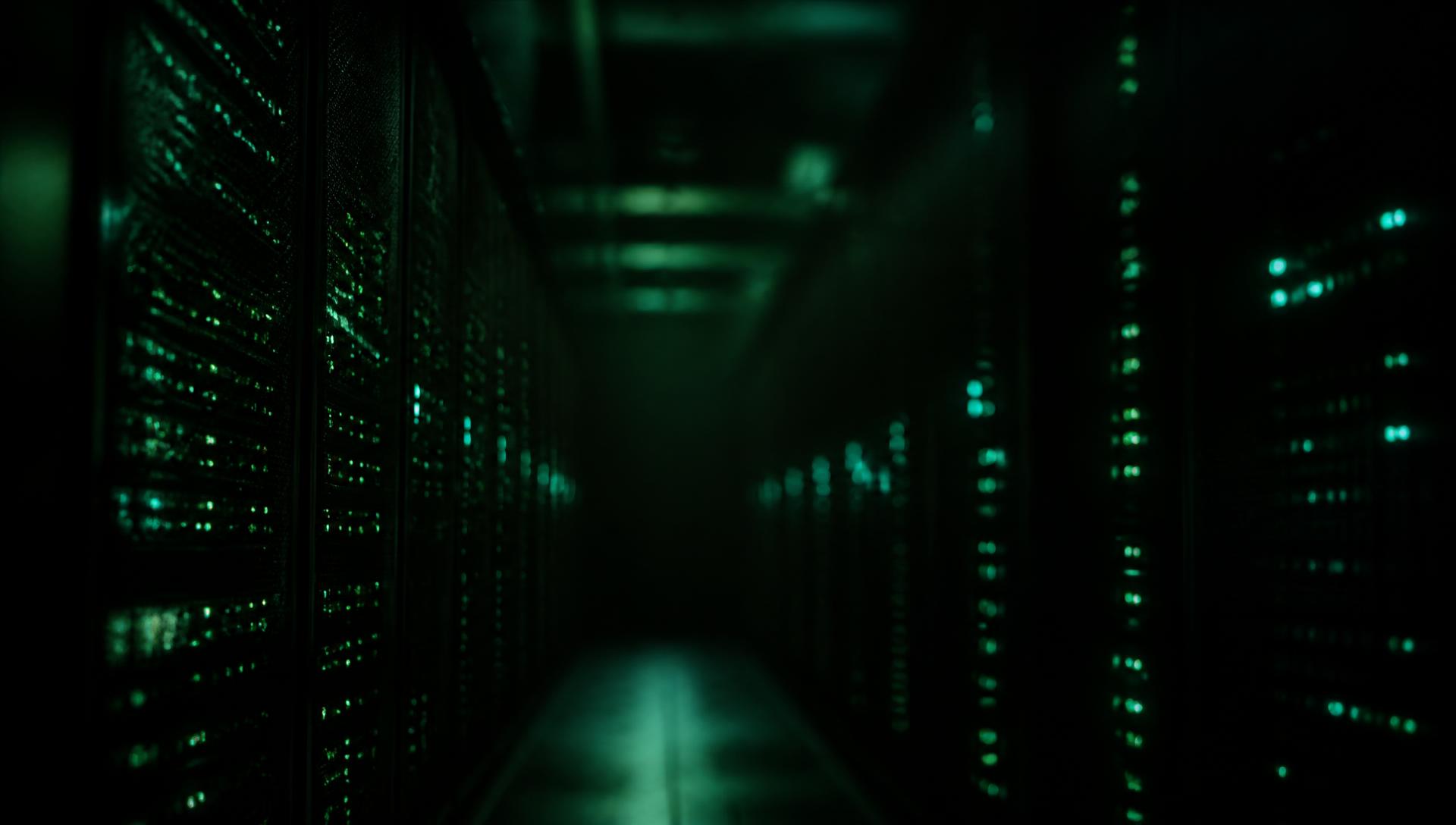 Dark corridor of servers lit in green